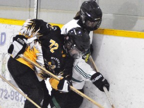 Corinn Lostell (72), a defenceman with the Mitchell U19A ringette team, pins this ring against the boards while checking this Kitchener opponent during Western Ontario Ringette League (WORL) action Sunday, Nov. 6 in Mitchell. The visiting Wildcats downed their hosts, 4-1. ANDY BADER MITCHELL ADVOCATE