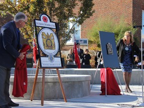 Strathroy-Caradoc Lions Club secretary Barry Wolfe and Strathroy-Caradoc Mayor Joanne Vanderheyden unveil one of the banners and plaques to be used for the Veterans Memorial Way and the wall in front of the local Cenotaph. JONATHAN JUHA/ STRATHROY AGE DISPATCH/ POSTMEDIA NETWORK