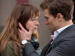 In this image released by Universal Pictures and Focus Features, Dakota Johnson, left, and Jamie Dornan appear in a scene from the film, “Fifty Shades of Grey.” (AP Photo/Universal Pictures and Focus Features)