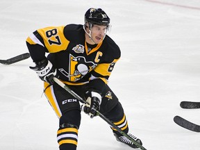 In this Oct. 27, 2016, file photo, Pittsburgh Penguins centre Sidney Crosby skates with the puck during an NHL hockey game against the New York Islanders. (AP Photo/Fred Vuich, File)