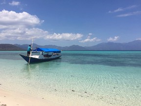 In this August 2016 photo, a local captain guides his boat near Pangabatang Island in Indonesia. Home to more than 13,000 islands, Indonesia is the world's largest archipelago. Though only about 6,000 are inhabited, that still leaves a lot of island hopping for beach and scuba enthusiasts. (Kristi Eaton via AP)