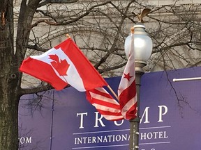 Canadian and American flags fly on Washington's Pennsylvania Avenue in front of a Trump International Hotel sign on Monday, March 7, 2016. THE CANADIAN PRESS/Alexander Panetta