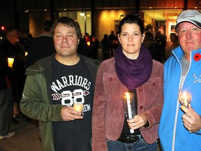 Event organizers Steve Loxton (left), Kelly Ash and Dan Harding stand in front of a candlelight vigil at Sarnia City Hall on Monday, Nov. 7, 2016 in Sarnia, Ont. The two-hour event was meant to honour workplace harassment victims and raise awareness on the issue. (Terry Bridge/Sarnia Observer)