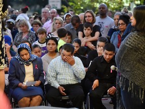 Efrain Gomez, center, wipes his eye, while seated next to his wife, Balvina, left, during a vigil for their daughter Kayla Gomez-Orozco at Jack Elementary School in Tyler, Texas, Sunday, Nov. 6, 2016. Investigators said the 10-year-old East Texas girl reported missing from church has been found dead in a water well and a relative was held as the lone suspect in the slaying. (Andrew D. Brosig/Tyler Morning Telegraph via AP)