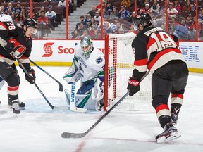 Derick Brassard of the Ottawa Senators looks at his options as Matt Puempel battles for position during a game against the Vancouver Canucks at Canadian Tire Centre on Nov. 3, 2016 in Ottawa. (Francois Laplante/Freestyle Photography/Getty Images)