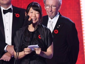 Madeleine Thien, left, gives an acceptance speech after winning the 2016 Giller Prize for her book "Do Not Say We Have Nothing" as Giller Prize founder Jack Rabinovitch looks during an award ceremony on in Toronto, Monday, Nov. 7, 2016. THE CANADIAN PRESS/Frank Gunn