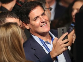 Mavericks owner Mark Cuban banned ESPN writers Marc Stein and Tim MacMahon from Dallas home games to spotlight his concerns that automated game reports could eventually replace human-generated content. (Joe Raedle/AP Photo/Files)