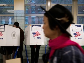 People vote at a polling site at Public School 261, November 8, 2016 in New York City. Citizens of the United States will choose between Republican presidential candidate Donald Trump and Democratic presidential candidate Hillary Clinton. (Photo by Drew Angerer/Getty Images)
