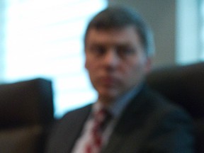 Lawyer Daniel Macdonald listens to his client, a juror from the trial of Michael Rafferty, who was convicted of first degree murder in the death of 8 year old Tori Stafford, at the office of Legate and Associates LLP in London, Ont. Derek Ruttan/The London Free Press