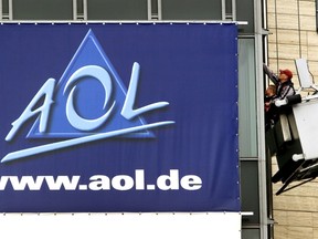 In this March 17, 2000, file photo, window cleaners work at the front of the headquarters of AOL Europe in Hamburg, Germany. A California woman stumbled upon a voice from the past during a trip to Ohio over the weekend when she discovered her Uber driver was the man behind America Online’s famous “You’ve Got Mail” greeting. Brandee Barker was in the Cleveland area to campaign for Hillary Clinton when she got into an Uber driven by Elwood Edwards. After Edwards told her about his claim to fame, she took a video of him saying the phrase and posted it on Twitter on Nov. 5, 2016. (AP Photo/Michael Probst, File)