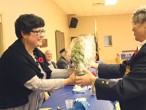 The branch service officer from the Seaforth Legion, Lin Steffler presents flowers to Major George Garrard’s wife last Saturday.(Shaun Gregory/Huron Expositor)