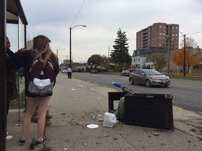 Wreckage is scattered on the sidewalk after a car was struck and sent careering through an intersection teeming with students from Catholic Central High school Tuesday at noon.  (PATRICK MALONEY, The London Free Press)