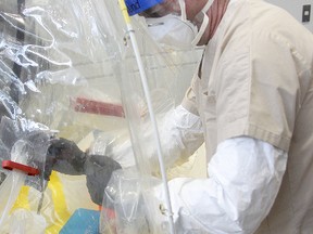 Technician Shane Jones demonstrates a mobile Ebola lab at the National Microbiology Lab in Winnipeg two years ago. On Tuesday, officials confirmed a lab worker may have been exposed to the deadly virus. (Brian Donogh/Winnipeg Sun file photo)