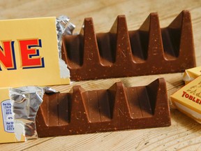 In this photo illustration two bars of the Toblerone Swiss chocolate are shown, at front is the new style 150 gram bar showing the reduction in triangular pieces, in the background is the older style 360 gram bar, pictured in London, Tuesday, Nov. 8, 2016. More valleys, fewer chocolate peaks: The maker of Toblerone Swiss chocolate says it's widened the spaces in its iconic, triangle-array bars for some discount shops in Britain to keep prices down. Mondelez International says the move aims to meet pricing targets by customer Poundland and other discount retailers, and has nothing to do with Britain's vote to leave the European Union. (AP Photo/Alastair Grant)