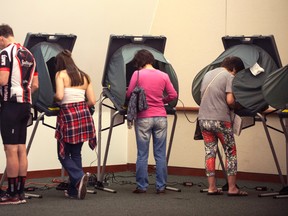 Voters cast their votes a day early at the City Hall in Irvine, Calif., Monday, Nov. 7, 2016. (Mindy Schauer/The Orange County Register via AP)