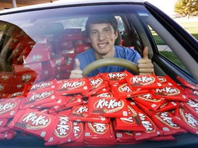 In this Nov. 3, 2016, photo Hunter Jobbins, freshman at Kansas State University, poses in his car filled with nearly 6,500 Kit Kat bars in Manhattan, Kansas. Jobbins told The Wichita Eagle he left his car unlocked with a Kit Kat in the cupholder last month before running into his dorm building. When he came back, the candy bar had been replaced with a note. The thief wrote, “I love Kit Kats so I checked your door and it was unlocked. Did not take anything other than the Kit Kat. I am sorry and hungry.” Jobbins’ picture of the note went viral on Twitter and Hershey responded by sending a representative to the campus with 6,500 Kit Kat bars. (Colin E. Braley/AP Images for The Hershey Company)