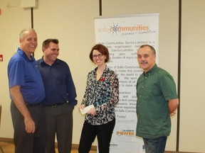 Members of Safe Communities Sarnia-Lambton present a cheque of $450 to Lambton Circles' Megan O'Neil. Left to right: Safe Communities' Mark Roehler and Rob Janoska, Lambton Circles' Megan O'Neil, Safe Communities' Dante Cateni. 
CARL HNATYSHYN/SARNIA THIS WEEK