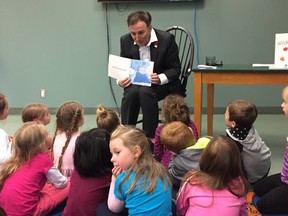 Ernst Kuglin/The Intelligencer
MP Neil Ellis reads to Harmony Public School students in Trenton at the Quinte West Public Library. Ellis attended the library Tuesday as part of the Bay of Quinte Canada 150 Literacy Challenge.