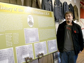 CHRIS ABBOTT/TILLSONBURG NEWS
Justin Carpani, president of the Tillsonburg Military History Club, helped set up the Week of Remembrance exhibit at the Station Arts Centre on Monday. It will be on display for the rest of the week.