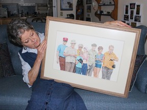 Woodstock artist Eleanor Kent is hoping to find a home for her painting, based on a 1976 photograph of an art class at Dorchester Pond. The subjects of the photograph, from left to right, Carl Rath, John Speirs, Harry Whitwell, Jeff Rath, Judy Wylie, Andrew Petrie, Eleanor Kent, and Joe Keane. (MEGAN STACEY/Sentinel-Review)