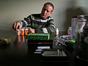 Luke Hendry/The Intelligencer
Nate Craig, 35, displays some of the medications, forms of medical marijuana, digestive aids and other products he uses to control chronic pain and the drugs' side effects at his home in Belleville Tuesday. The victim of a 1999 car accident has prescriptions for painkillers and marijuana but said staff of Kingston General Hospital prevented him from using cannabis products while he was admitted there following spinal surgery.