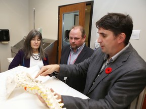 Dr. Scott Duggan, right, program manager of the chronic pain clinic at Hotel Dieu Hospital, gives a tour of the facility to Kingston and the Islands MPP Sophie Kiwala and Mike McDonald, the hospital's chief of patient care. The clinic received more than $1.6 million to expand its services. (Elliot Ferguson/The Whig-Standard)