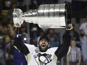 Hoisting the Stanley Cup over his head this past spring, Justin Schultz says he has no hard feelings toward the Oilers for being traded to Pittsburgh last season. (AP Photo)