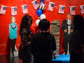 Enjoying a game of Jenga, with cut outs of the presidential candidate in the background during a watch event for the 2016 United States Presidential Election held at Ada Slaight Hall, Daniels Spectrum, in Toronto, Ont. on Tuesday November 8, 2016. Ernest Doroszuk/Toronto Sun/Postmedia Network