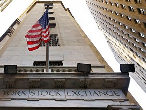 In this Friday, Nov. 13, 2015, file photo, the American flag flies above the Wall Street entrance to the New York Stock Exchange. Global stock markets were steady Tuesday, Nov. 8, 2016, following strong Wall Street gains the day before, as investors focused on the final hours of a tight U.S. presidential race. (AP Photo/Richard Drew, File)