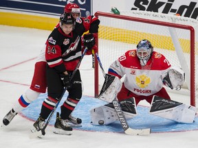 Team WHL's Deven Sideroff battles Team Russia's Artem Minulin in front of goalie Vladislav Sukhachev during first period action Tuesday at Rogers Place. (David Bloom)