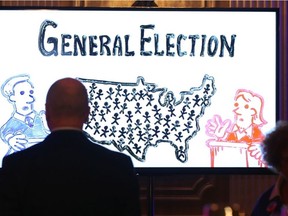 US Ambassador Bruce Heyman watches a TV screen during Tuesday night's viewing party at the Chateau Laurier.