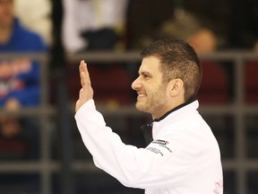 Craig Savill salutes the crowd after the opening ceremonies during the Tim Hortons Brier held at TD Place in Ottawa on March 10, 2016. (Jean Levac/Postmedia/Files)