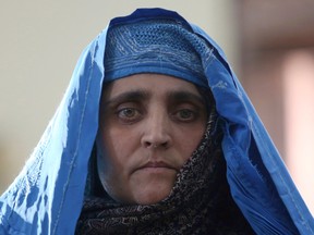 National Geographic's famed green-eyed "Afghan Girl" Sharbat Gulla poses for a photo during a meeting with Afghan President Ashraf Ghani, at the Presidential palace in Kabul, Afghanistan, Nov. 9, 2016. Afghanistan's president on Wednesday welcomed home Gulla who was deported from Pakistan after a court had convicted her on charges of carrying a forged Pakistani ID card and staying in the country illegally. (AP Photo/Rahmat Gul)
