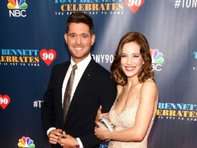 In this Sept. 15, 2016 file photo, Michael Buble, left, and wife Luisana Lopilato, attend "Tony Bennett Celebrates 90: The Best Is Yet to Come" at Radio City Music Hall, in New York. (Photo by Andy Kropa/Invision/AP File)
