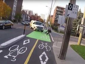 Screen grab from video of a man cycling in the O'Connor Street bike lanes  who was knocked to the ground by a van Tuesday.