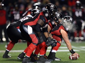 The breath of the Ottawa Redblacks can be seen in the cold air as they take on the Winnipeg Blue Bombers during second half of CFL action in Ottawa on Friday, Nov. 4, 2016. (THE CANADIAN PRESS/Sean Kilpatrick)