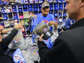 Cubs fans purchase clothing at Sportsworld Chicago near Wrigley Field in Chicago, Thursday, Nov. 3, 2016. (AP Photo/Matt Marton)