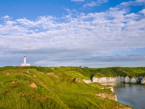 Lighthouse, chalk cliffs and the North Sea are pictured at dawn on a fine summer morning near Flamborough Head in England. A man from Bridlington, England, admitted to kidnapping his wife, then abandoning her in the town of Flamborough. (Danielrao/Getty Images)