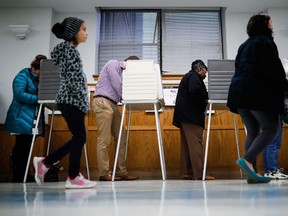 In this Nov. 8, 2016 file photo, voters fill out their ballots at the Nativity School polling place on election day, in Cincinnati.  (AP Photo/John Minchillo, File)