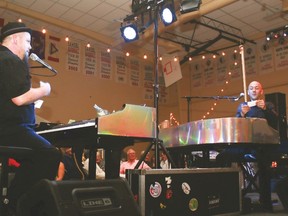 Burn ’N’ Mahn dueling pianists Brian Burns, left, and Jamie Mahn read out song requests from audience members at the Fall Harvest Celebration Saturday evening at the Cultural-Recreational Centre. Jasmine O'Halloran