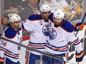 Patrick Maroon, middle, celebrates his goal with teammates Jordan Eberle, left, and Adam Larsson during the first period of Tuesday's game in Pittsburgh. (AP Photo)