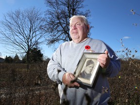 Ted Sharpe holds a photograph of his father, Dale Sharpe, on Wednesday. Dale Sharpe was a sniper in the Canadian army when he was killed in action late in the Second World War. His exploits are included in a new film set to premiere in Toronto on Remembrance Day. (Elliot Ferguson/The Whig-Standard)
