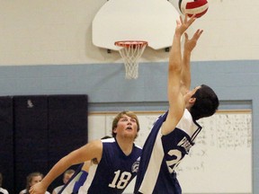 St. Mary's Warriors Ryan Sloan, right, sends the ball airborne as Dylan Bukta prepares to spike it in Woodstock, Ont. at St. Mary's Catholic high school against St. Joseph's of St. Thomas on Monday November 7, 2016. St. Mary's won 3-1, but lost Wednesday with regional high school playoffs closing in on WOSSAA finals. Greg Colgan/Woodstock Sentinel-Review/Postmedia Network