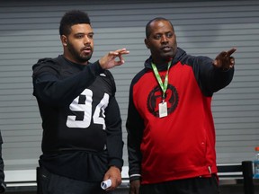 Cleyon Laing (left) and defensive coach Leroy Blugh chat during last week’s walkthrough. (JEAN LEVAC/Postmedia Network)