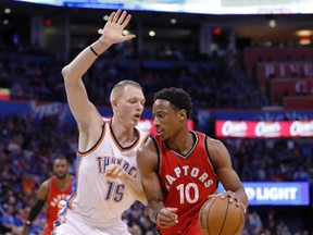 Thunder forward Kyle Singler (15) defends as Raptors guard DeMar DeRozan (10) drives to the basket during first half NBA action in Oklahoma City on Wednesday, Nov. 9, 2016. (Alonzo Adams/AP Photo)