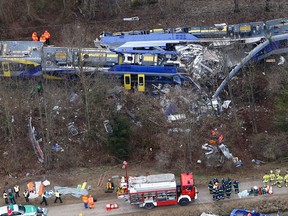The Feb. 9, 2016 file photo shoes an aerial view of rescue teams at the site where two trains collided head-on near Bad Aibling, Germany. On Thursday, Nov. 10, 2016 a train dispatcher is going on trial charged with 12 counts of negligent homicide and 89 counts of causing bodily harm in the collision of the two commuter trains in southern Germany. (AP Photo/Matthias Schrader, file)