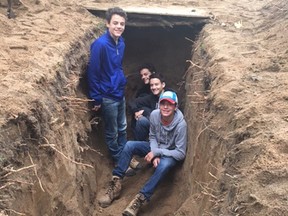 École secondaire catholique Jeunesse-Nord students Kyler Folz, Kale Goudreau, Brady Roberts and Spencer Roberts dug a life-sized model of a military trench. Supplied photo
