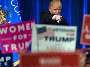 FILE - In this Tuesday, Nov. 1, 2016, Republican presidential candidate Donald Trump gestures during a campaign state at the University of Wisconsin-Eau Claire in Eau Claire, Wis. In his victory speech, Trump called them America’s “forgotten men and women”, the workers from the coalfields of Appalachia to the hallowing manufacturing towns of the Rust Belt who propelled him to an improbable victory. They felt left behind by progress, laughed at by the elite, and so put their faith in the billionaire businessman with a sharp tongue and short temper. (AP Photo/Matt Rourke, File)