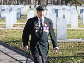 Second World War veteran Rifleman John Stoyka of the Royal Winnipeg Rifles walks through the Field of Honour at Brookside Cemetery last Sunday. (Brian Donogh/Winnipeg Sun)