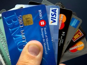Credit cards are displayed in Montreal, Wednesday, December 12, 2012. The amount Canadians owe compared with how much they earn hit a new record in the second quarter, driven in part by the country's hot housing markets. (THE CANADIAN PRESS/Ryan Remiorz)